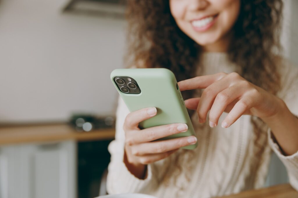 Woman wearing sweater hold use mobile cell phone