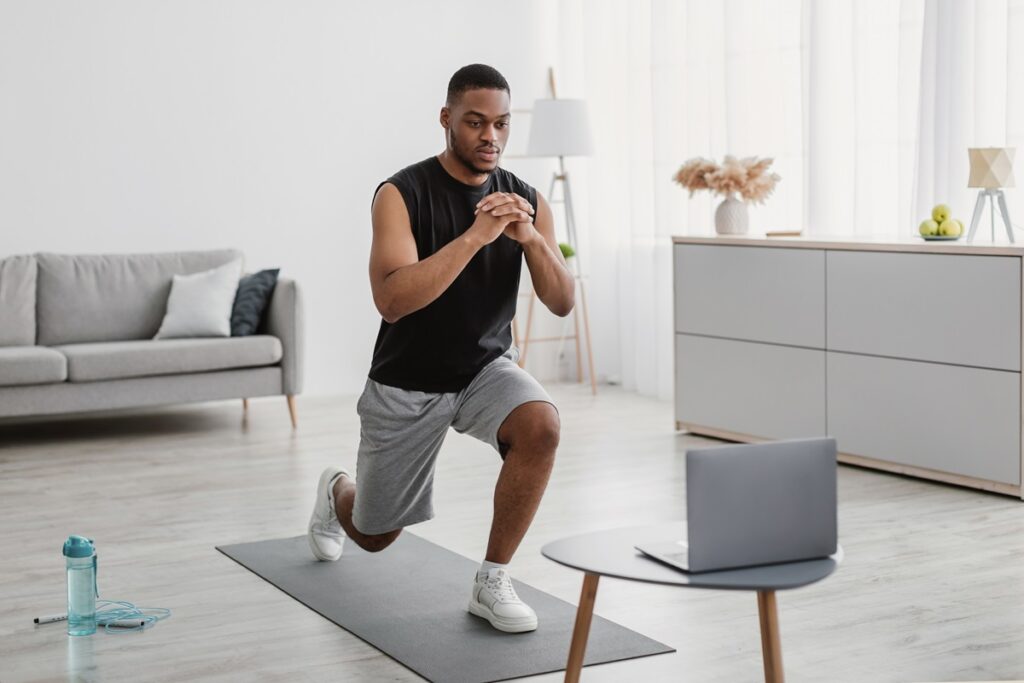 Man Training using Laptop Computer at home